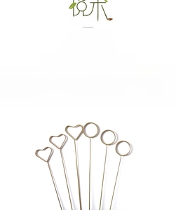 Close-up of gold metal floral card holders in heart and circle shapes for flower shops