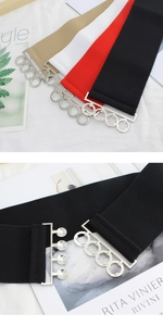 Close-up of four-ring silver buckle on wide elastic corset waist belt for women
