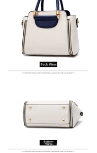 Detail view of contrast color handbag showing the back side and bottom metal feet studs