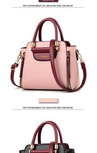 Detail of color-block tote bag showing metal hardware and detachable shoulder strap