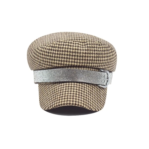 Detailed view of houndstooth newsboy hat featuring a sparkling rhinestone band and silver buckles