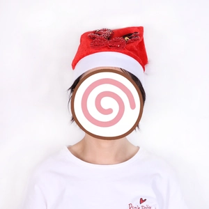Detail of a red plush Christmas hat featuring a shiny sequin bow and reindeer antlers