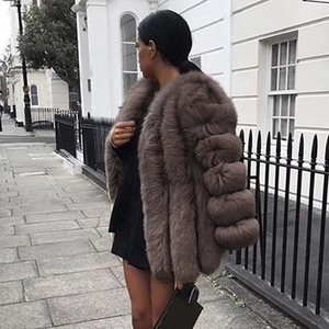 Women's faux fur coat in brown featuring a tiered sleeve design and longline silhouette