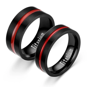 Detail of titanium steel rings featuring black enamel and red decorative lines