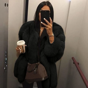 Chic black faux fur long coat for women featuring a thick plush texture in a mirror selfie