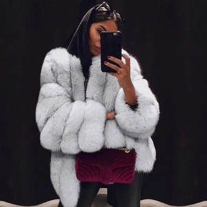 Detailed mirror selfie of a plush white faux fur jacket with long sleeves and thick texture