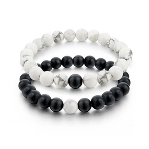 Detail of beaded bracelet set featuring black lava stone and white marble texture beads
