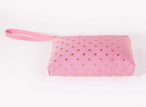 Detail of pink fabric makeup bag with golden polka dots and durable zipper closure