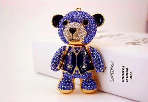 Macro shot of teddy bear keychain with blue rhinestones and gold-plated enamel detail