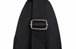 Detail of black nylon shoulder strap with a polished metal adjustment buckle for multi-use bag