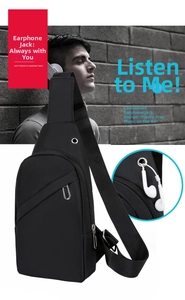 Detail view of the functional headphone jack and durable black nylon crossbody chest bag