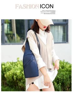 Detail of navy blue waterproof sling bag with metal zippers and adjustable strap