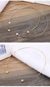 Detailed close-up of hexagonal zircon pendants on gold and silver stainless steel neck rings