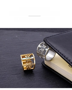 Macro detail of gold and silver stainless steel rings with shell inlay and leaf cutouts