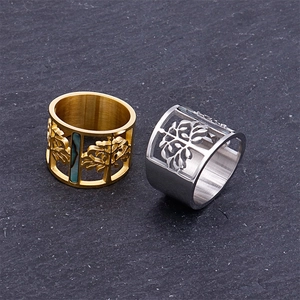 Gold and silver stainless steel cutout life tree rings on dark slate background