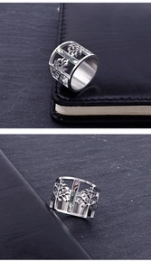 Detailed view of silver tree of life ring with rainbow shell inlay on a leather surface
