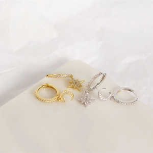 Detail of S925 sterling silver star and moon asymmetric earrings in gold and silver