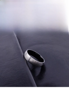 Close-up of titanium steel ring featuring brushed silver exterior and black polished inner band