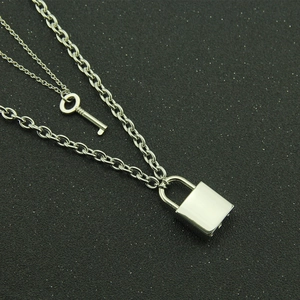 Fashionable silver double layer necklace featuring geometric key and lock pendants