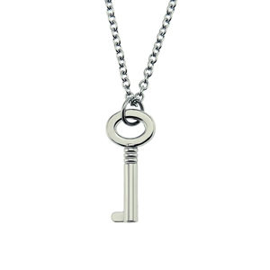 Detailed close-up of a polished silver metal key pendant with a delicate link chain