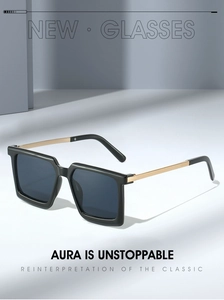 Detail view of stylish square sunglasses with black acetate frames and gold metal temples