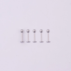 Macro detail of five silver 316L stainless steel labret studs with flat back and ball top