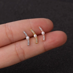 Flower zircon ear bone studs in silver, gold, and rose gold finishes on fingers