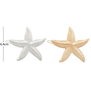 Detail view of gold and silver starfish hair clips with a textured alloy surface