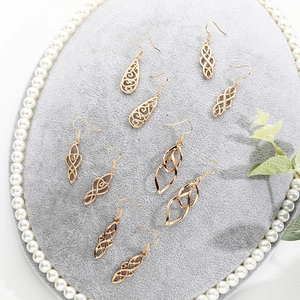 Detailed set of gold plated dangle earrings with retro hollow geometric patterns