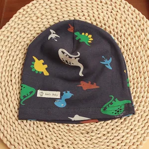 Detail view of the durable double-stitched seam on a soft cotton baby dinosaur beanie