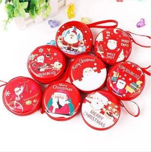 Flat lay of round tinplate Christmas coin purses with festive Santa Claus patterns