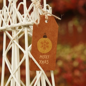 Mini brown kraft paper Christmas gift tag with Merry Xmas text and snowflake pattern