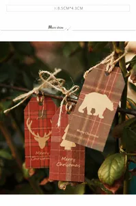 Close-up of vintage kraft paper Christmas tags with animal patterns and rustic twine