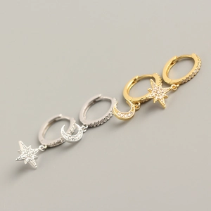 Detail of gold and silver S925 sterling silver star and moon asymmetric hoop earrings