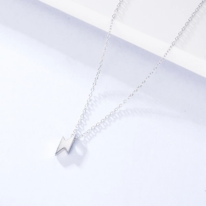 Detailed close-up of a minimalist S925 sterling silver lightning bolt pendant necklace