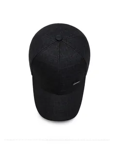 Top down view of black plaid baseball cap featuring a premium crosshatch fabric texture