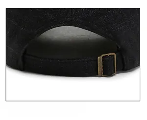 Detailed close-up of adjustable strap and bronze buckle on plaid pattern baseball cap