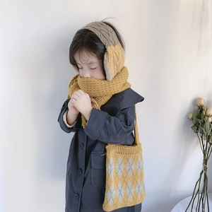 Detail of yellow knit scarf and diamond pattern crossbody bag for children