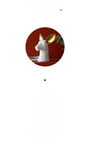 Close-up of white ceramic animal head vase with elegant gold-painted ear accents