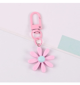 Detailed view of pink daisy keychain with blue center and matching lobster clasp