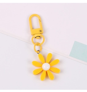 Close-up of a yellow daisy flower keychain with a matching yellow metal spring clasp