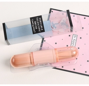 Macro shot of 4-in-1 portable telescopic makeup brush in pink with synthetic bristles