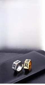 Detail of hexagonal titanium rings in gold and silver with engraved Buddhist mantras