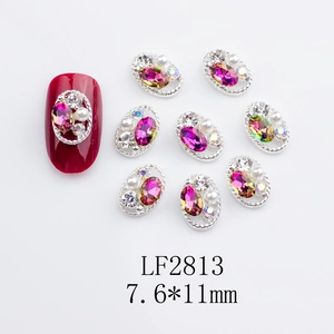 Macro detail of LF2813 oval rose red nail art charms with twisted silver rim 7.6x11mm
