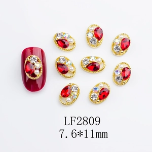 Detailed view of LF2809 nail art alloy charm with red teardrop gem and twisted gold frame