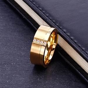 Gold brushed titanium steel ring with 4 inlaid diamonds on black leather and stone base