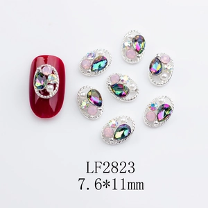 Detailed view of silver oval alloy nail charms with crystals and pearls in 7.6*11mm size