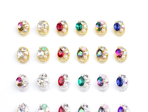 Detailed array of oval alloy nail charms with colorful crystals and pearl inlays