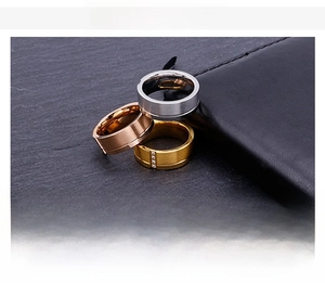 Detail view of frosted titanium steel rings with diamond inlay and center groove design