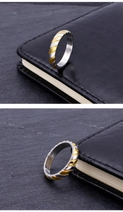 Detail view of two-tone gold and silver striped stainless steel ring for couples